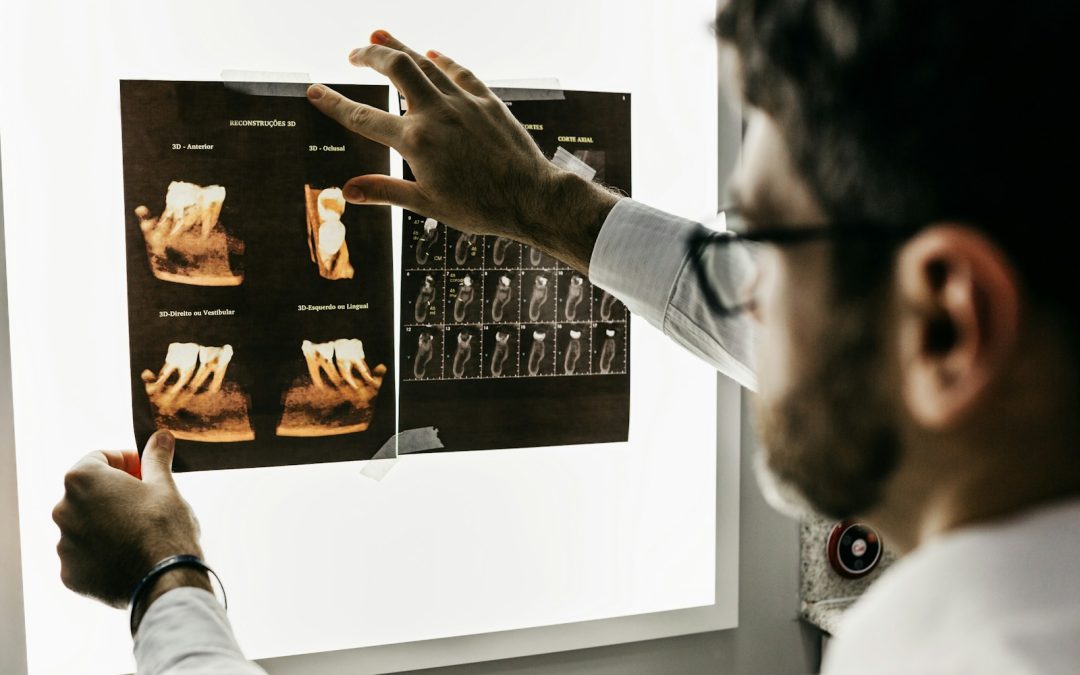 person in gray long sleeve shirt holding black tablet computer